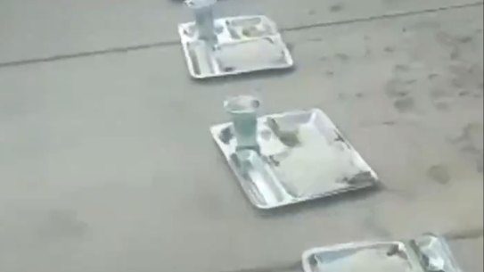 Canteen trays form a long line on the pavement outside Isfahan University of Technology in Isfahan, Iran. 