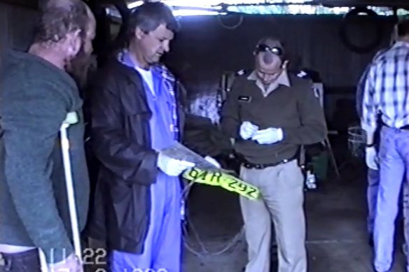 Francis Wark accompanying police during a search of his home in August 1999. 