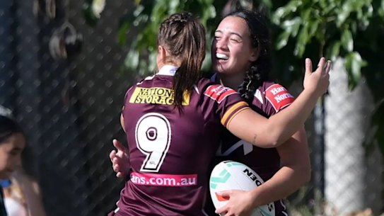 Kerri Johnson celebrates scoring one of her two tries on her NRLW debut.