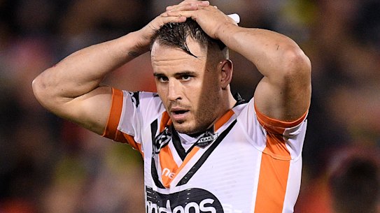 Tigers playmaker Josh Reynolds has been charged with assaulting his former partner. He denies the allegation.