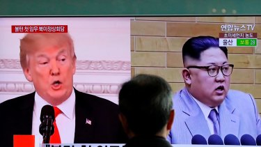 A man watches a TV screen showing file footage of US President Donald Trump, left, and North Korean leader Kim Jong-un, in Seoul.