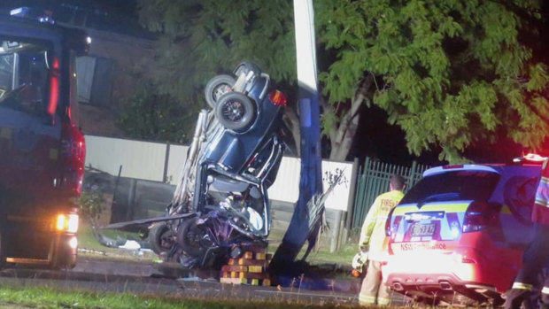 Four young men were trapped in after their car collided with a power pole in Girraween. 