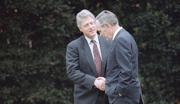 George H. W. Bush shakes hands with president-elect Bill Clinton after an Oval Office meeting in Washington on November 18, 1992. The two men became close friends post-politics.