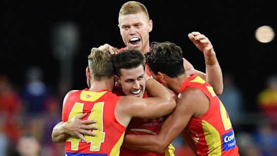 Suns players celebrate after beating the Dockers in round 2.