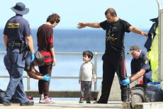 First taste of Australia: Kosar Kalantari, her son Hossain and her husband Eric Mohammadi in the photograph taken on Christmas Island and published in Fairfax newspapers in 2013.