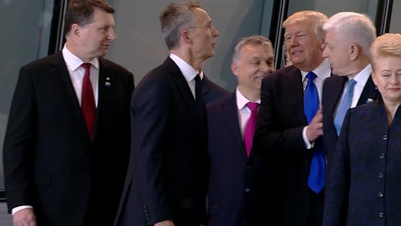Getting ahead: US President Donald Trump pushes Montenegro Prime Minister Dusko Markovic, second right, at the NATO meeting in Brussels in May.