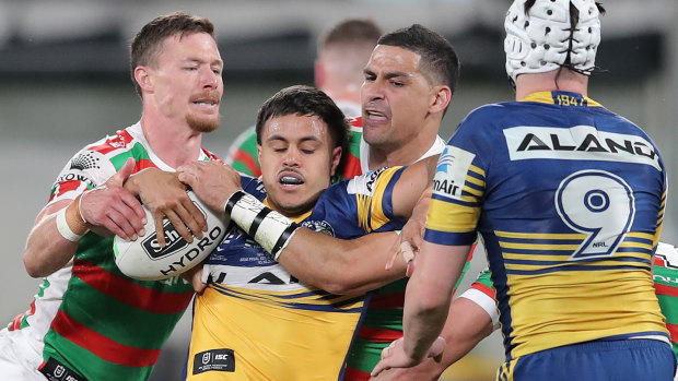 Haze Dunster is wrapped up by the Rabbitohs during a tough NRL debut last season.
