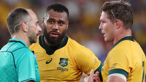 Referee Romain Poite speaks with Samu Kerevi and Wallabies captain Michael Hooper. 