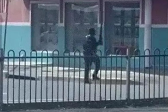 Video shows a masked man appearing to fire shots outside a store in Windang, near Wollongong. 