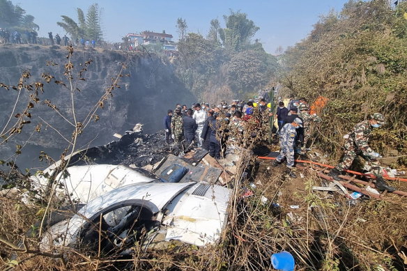 Rescue teams working at the wreckage of a Yeti Airlines ATR72 aircraft after it crashed in Pokhara, Nepal,