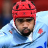 The Waratahs Langi Gleeson is tackled during Round One Super Rugby Pacific against the Reds in Brisbane