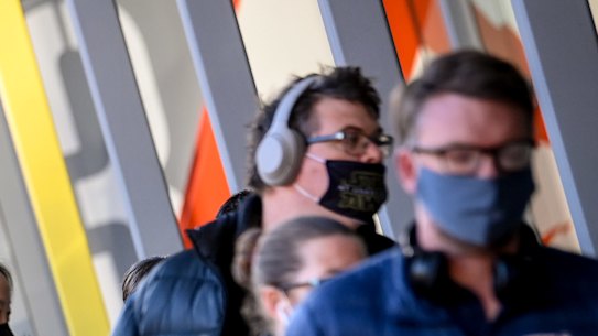 Safety first: People queue up for COVID-19 vaccination at the Melbourne convention centre.