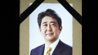 A portrait of former Japanese prime minister Shinzo Abe hangs on the stage during the state funeral. 