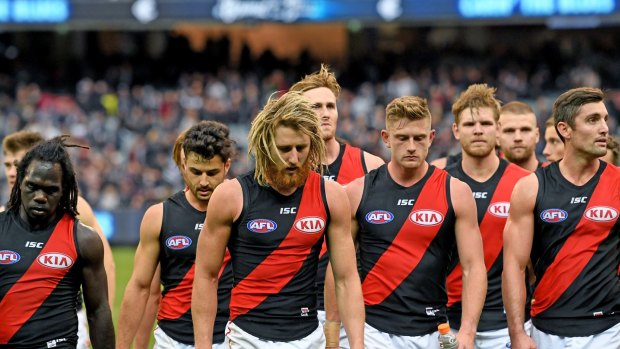 Dejected: Essendon players trudge off the ground after their round 8 loss to Carlton. 