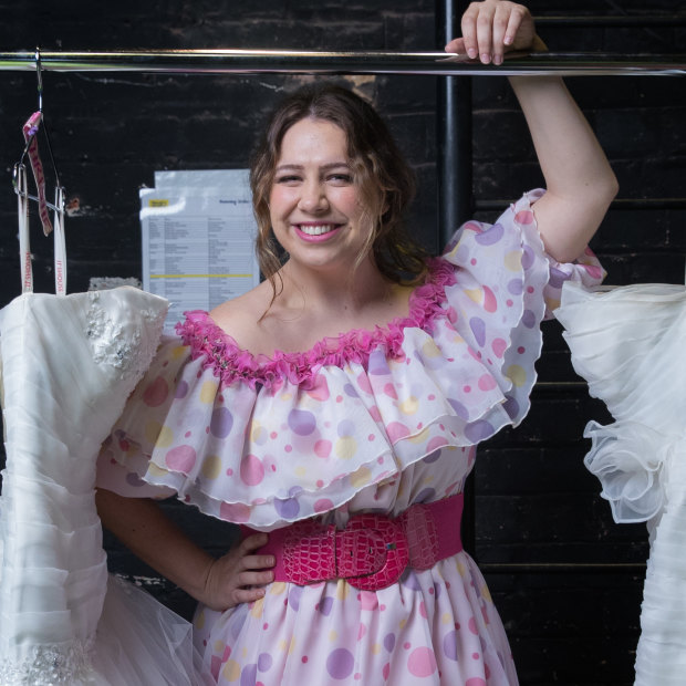 Natalie Abbott, who plays Muriel Heslop in Muriel's Wedding the Musical, backstage with a selection of the show's 30 wedding dresses.