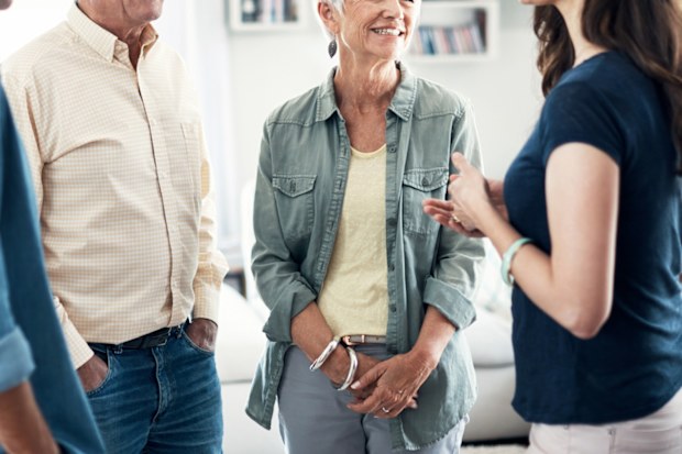 Shot of a young couple and their elderly parent spending some time together at home Sour