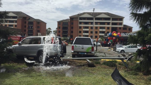 A silver Honda CR-V came to rest on a burst water main after a  truck ploughed through cars at Fairy Meadow McDonald’s near Wollongong.