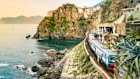 A train rolls through Manarola, Cinque Terre.