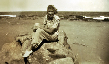 Necia Combe at what is thought to be Cronulla beach relaxing from her duties with the Australian Women's Land Army.