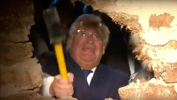 US Ambassador to Israel David Friedman uses a sledgehammer to smash the last remaining wall in front of the Pilgrimage Road at a ceremony in East Jerusalem.