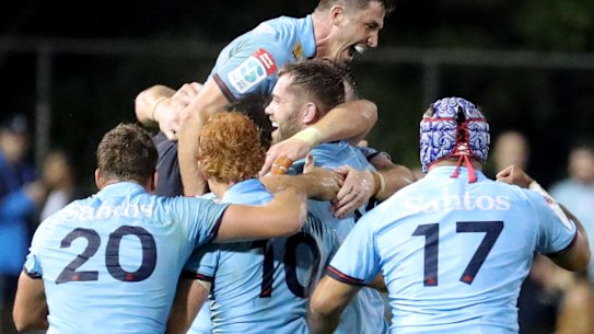 Waratahs players celebrating after beating the Crusaders.