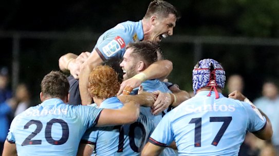 Waratahs players celebrating after beating the Crusaders.