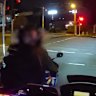 Police pull up beside a motorcycle in Mount Gravatt before arresting the rider.