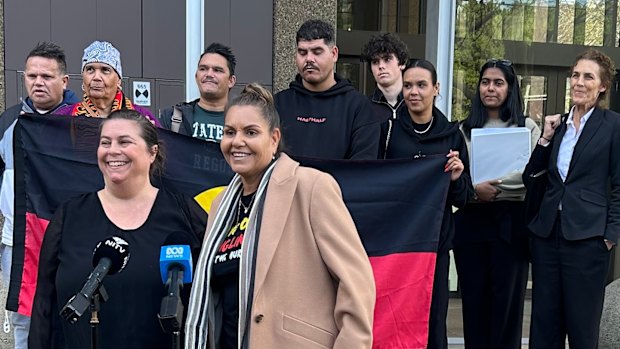 Raelene Cooper, lawyers and supporters address media outside the Federal Court in Sydney this morning.