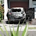 The charred shell of an SUV was seen in the driveway of the Moorebank home following the attack.