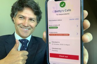NSW Customer Service Minister Victor Dominello displays the check-in app.