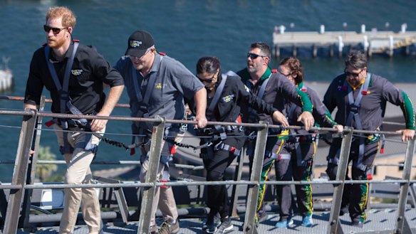 Britain's Prince Harry, Prime Minister Scott Morrison and Invictus Games representatives climb the Sydney Harbour Bridge on Friday.