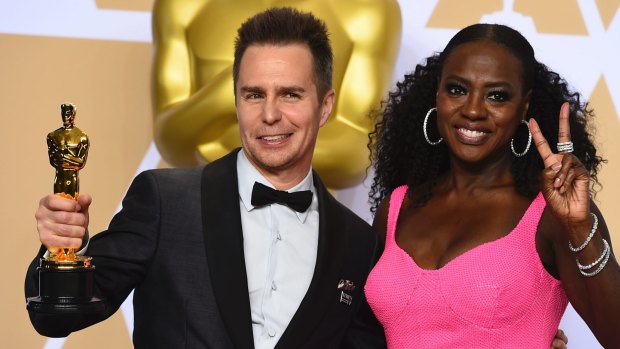 Sam Rockwell (best supporting actor for his role in "Three Billboards Outside Ebbing, Missouri") and Viola Davis at last year's Oscars ceremony.  The Hollywood glamour didn't reach disabled workers behind the scenes.