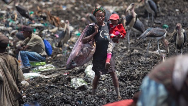 People scavenging for plastic at a garbage dump in the Dandora slum of Nairobi, Kenya, hunting for anything that can be recycled to earn themselves enough for their daily bread. 