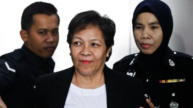 Australian Maria Elvira Pinto Exposto, centre, is escorted during a court hearing in Shah Alam, Malaysia, in 2017.