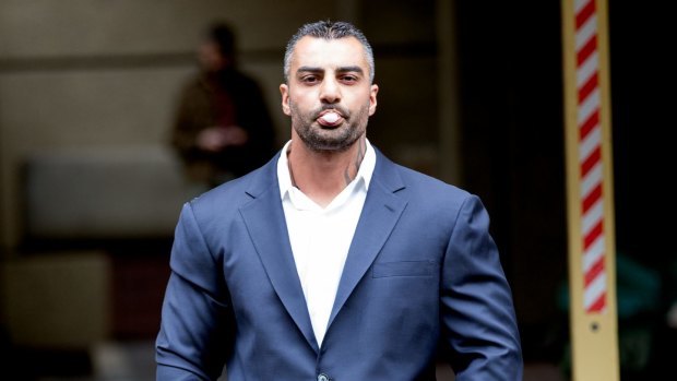 Blowing bubble gum at the camera, bikie boss Mick Hawi arrives at court for manslaughter over the Sydney Airport brawl in 2009.