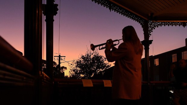 Sarah Brown, 23, plays The Last Post from the balcony of The Royal Hotel in Leichhardt.
