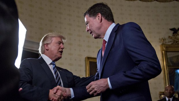 President Donald Trump greets then-FBI director James Comey with a handshake back in January, 2017.