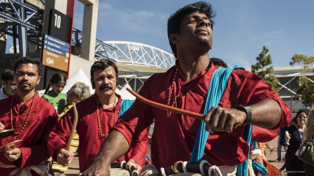 Australian Indians dancing and drumming in Sydney Olympic Park before Indian PM Narendra Modi arrives at a 2014 event.