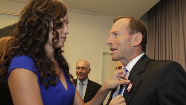Carla McGrath, pictured with then opposition leader Tony Abbott in 2013, is deputy chair of GetUp!