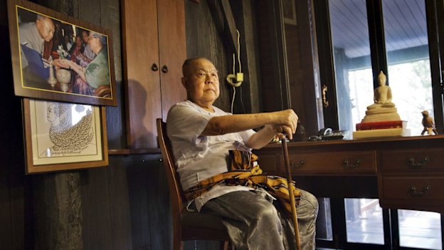 Sulak Sivaraksa, who has been charged or arrested five times under Thailand's lese-majeste law, at home in Bangkok. To the left is a photo of Sulak with the late king, Bhumibol Adulyadej.