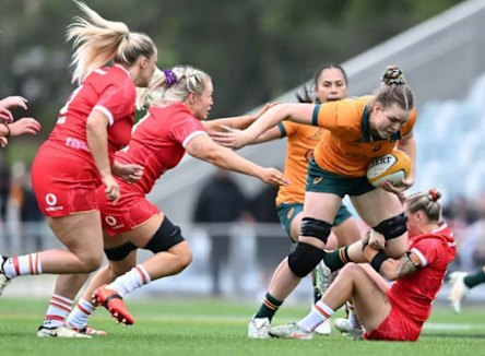 Australia’s Kaitlan Leaney takes it up to her Welsh opponents in the Test in Brisbane.