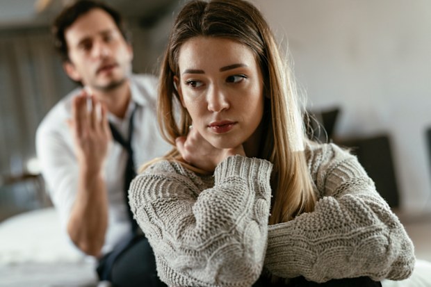 Man pleading with woman who is upset possibly husband and wife arguing.