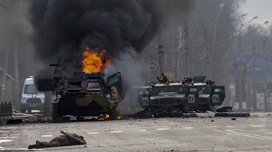 An armoured personnel carrier burns after fighting in Kharkiv, Ukraine’s second city.
