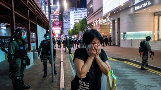 *** BESTPIX *** HONG KONG, CHINA - JULY 01: A woman covers her mouth as riot police fire pepper ball projectiles during a rally against a new national security law, on the 23rd anniversary of the city's handover from Britain to China on July 1, 2020 in Hong Kong, China. (Photo by Billy H.C. Kwok/Getty Images)