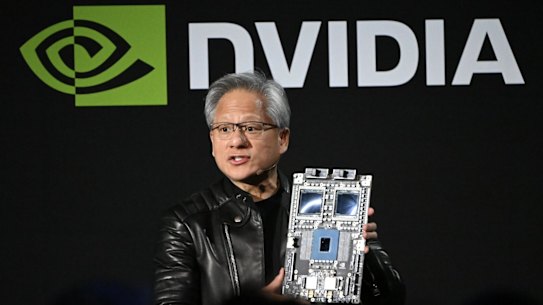 Jensen Huang holds up the