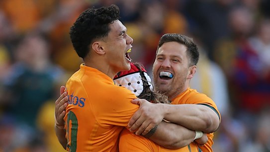  Noah Lolesio celebrates with try-scorer Fraser McReight.