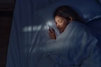 Woman in bed asleep - sleep research.