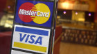 Mastercard and Visa are resisting attempts to regulate their processing fees and forcing them to be disclosed.