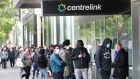 People queue to access Centrelink offices in March 2020. 