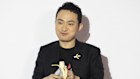 Crypto founder Justin Sun eats the organic part of Maurizio Cattelan’s Comedian, in Hong Kong after paying $9.6 million for it.